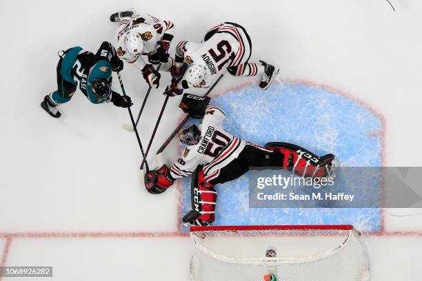 Corey Crawford, Artem Anisimov and John Hayden of the Chicago Blackhawks defend against a shot on goal by Ondrej Kase of the Anaheim Ducks during the...