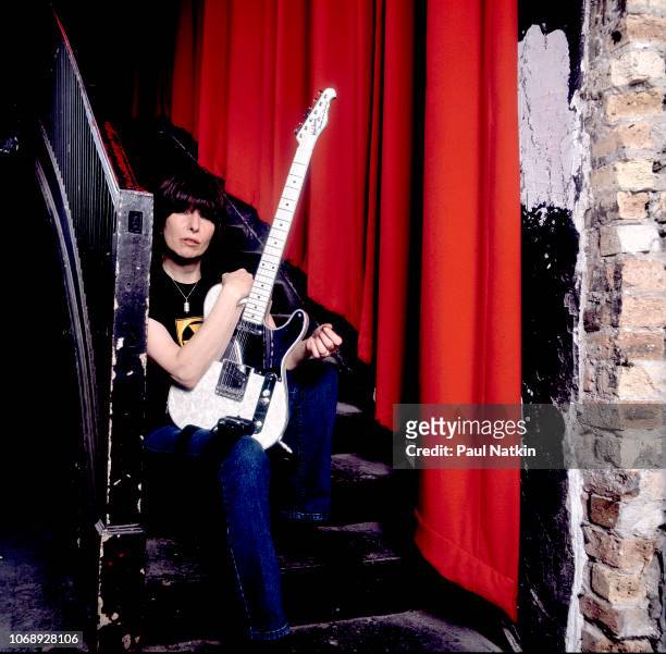 Portrait of American musician Chrissie Hynde, of the group Pretenders as she poses with her guitar, backstage at the Riviera Theater, Chicago,...