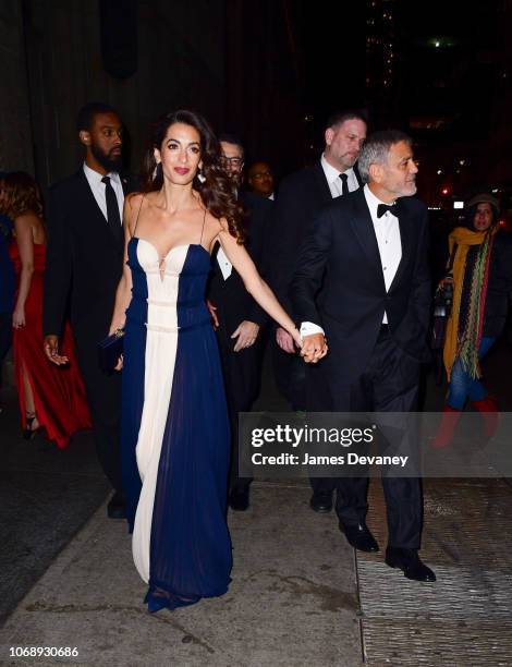 Amal Clooney and George Clooney leave Cipriani 42nd Street on December 5, 2018 in New York City.