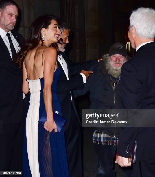 Amal Clooney and George Clooney greet Radioman outside Cipriani 42nd Street on December 5, 2018 in New York City.