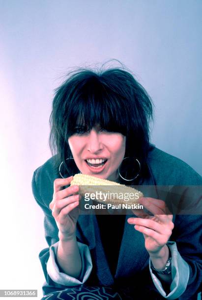 Portrait of American musician Chrissie Hynde, of the group Pretenders, as she eats corn on the cob at the UIC Pavillion, Chicago, Illinois, May 24,...