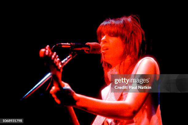 American musician Chrissie Hynde, of the group Pretenders, plays guitar as she performs at the Park West, Chicago, Illinois, April 25, 1980.