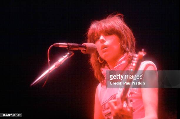 American musician Chrissie Hynde, of the group Pretenders, plays guitar as she performs at the Park West, Chicago, Illinois, April 25, 1980.
