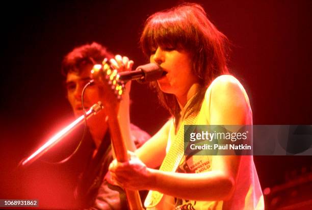 American musician Chrissie Hynde, of the group Pretenders, plays guitar as she performs at the Park West, Chicago, Illinois, April 25, 1980. Visible...