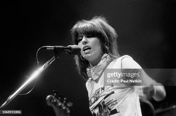 American musician Chrissie Hynde, of the group Pretenders, plays guitar as she performs at the Park West, Chicago, Illinois, April 25, 1980.