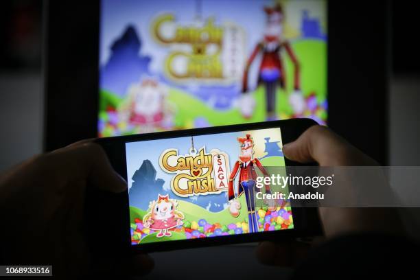 Man plays Candy Crush Saga game on smartphone in Ankara, Turkey on November 26, 2018.