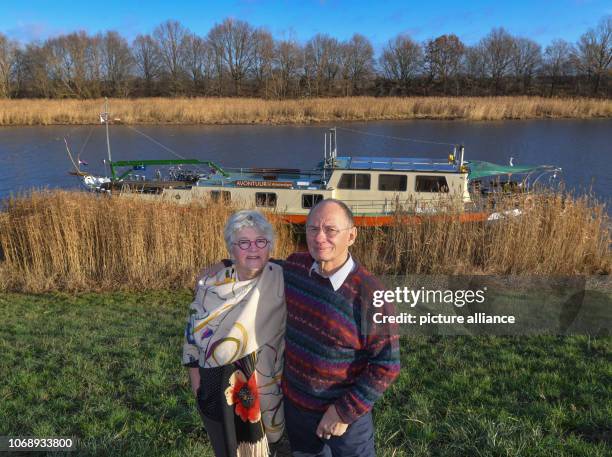 December 2018, Brandenburg, Kienitz: Marietta and Paul Kamstra, globetrotters from the Netherlands, are standing in front of their ship, the...