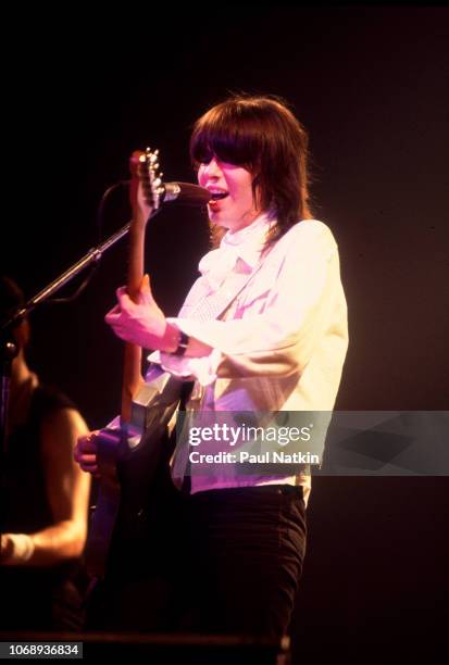 American musician Chrissie Hynde, of the group Pretenders, plays guitar as she performs at the Riviera Theater, Chicago, Illinois, September 8, 1980.