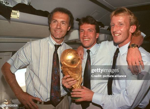 German team leader and head coach Franz Beckenbauer stands with German midfielder and team captain Lothar Matthaeus and German defender Andreas...