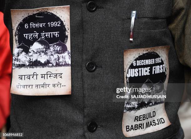 Pro-Muslim activist is seen with stickers pasted on his jacket on the 26th anniversary of the demolition of the 16th century Babri Masjid located in...