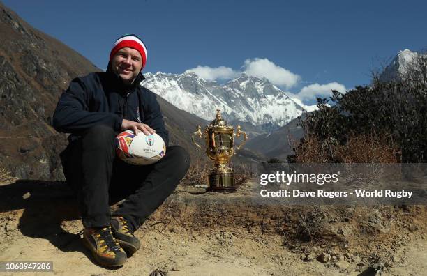 Former England international Ollie Phillips poses with the Webb Ellis Cup as he visits the Himalayas on day one of the Rugby World Cup 2019 Trophy...