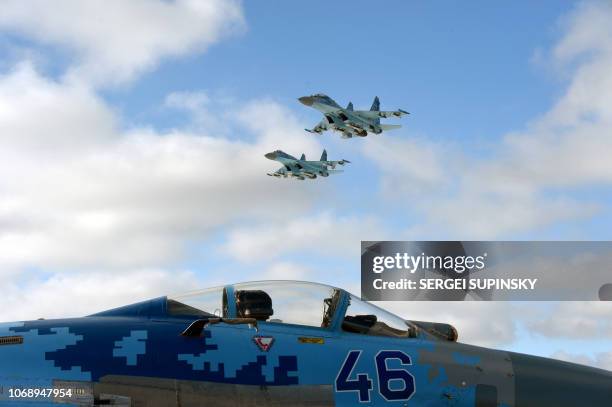 Ukrainian SU-27 planes fly over Ozerne air base, in Zhytomyr region in northern Ukraine, during a ceremony prior to the dispatch of Ukrainian troops...