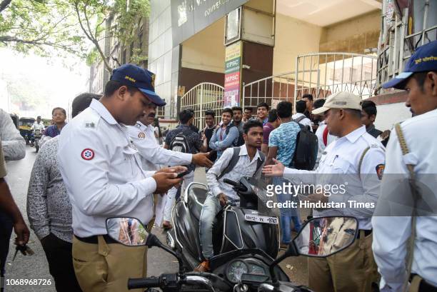 Traffic Police take an action against college students and others riding without helmets outside HV Desai College behind Shaniwar Wada, on December...