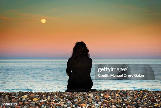 between heaven and earth  - moon shore stock pictures, royalty-free photos & images