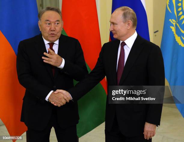 Russian President Vladimir Putin greets Kazakh President Nursultan Nazarbayev during the meeting on December 6, 2018 in Saint Petersburg, Russia....