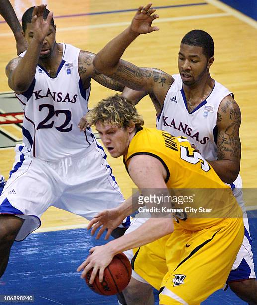 Marcus Morris, left, and his twin brother, Markieff, guard Valparaiso's Kevin Van Wijk during the second half of the Jayhawks' 79-44 win over the...