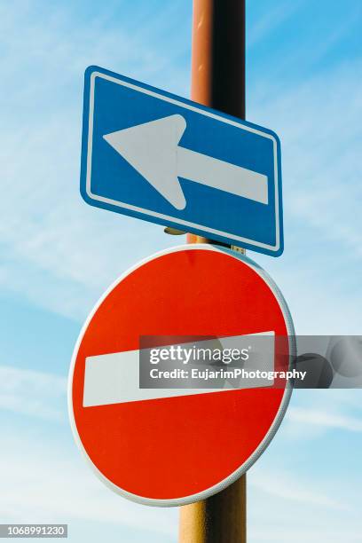 left arrow sign and do not enter sign isolated on blue sky background - no tresspassing sign stock pictures, royalty-free photos & images