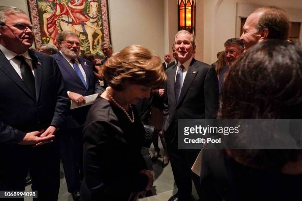 Former President George W. Bush, Laura Bush, front, Jeb Bush, left, and Neil Bush, right after a funeral service for former President George H.W....