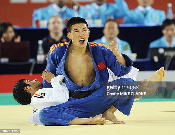 Lamusi of China jubilates a win over Ahmad al-Dheyabi of Kuwait during the men's Judo -60kg competition at the 16th Asian Games in Guangzhou on...