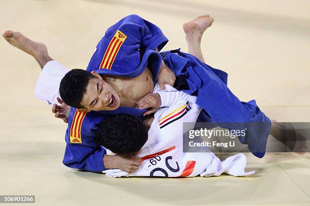 Lamusi of China competes against Ahmadtya Aldheyabi of IOC in the men's judo 60kg preliminary contest at the Huagong Gymnasium during day four of the...