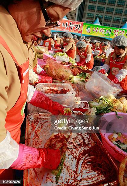 Thousands of housewives make Kimchi for donation to the poor in preparation for winter in front of City Hall on November 16, 2010 in Seoul, South...
