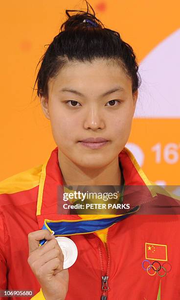 Tang Yi of China poses with her silver medal on the podium during the award ceremony for the women's 50m freestyle in the swimming event of the 16th...