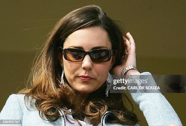 Britain Prince William's girlfriend Kate Middleton stands in the royal box on the Gold Cup day of the annual Cheltenham Race Festival at Cheltenham...