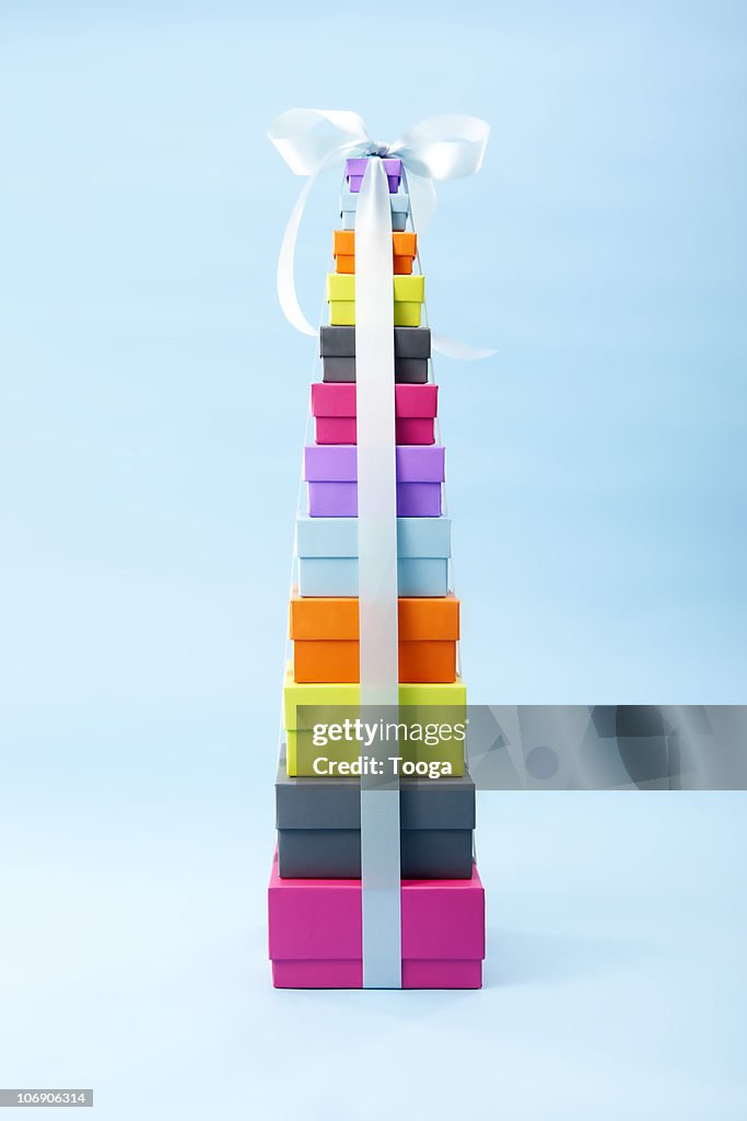 Colorful graduated stack of presents with ribbon
