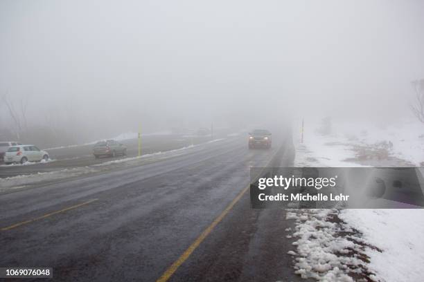 car driving in low visibility road in australia in snow - snow victoria australia stock pictures, royalty-free photos & images