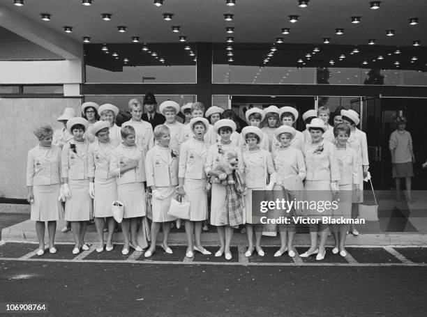 Female athletes from the British Olympic team line up outside their hotel before a visit to Buckingham Palace, 27th October 1964.