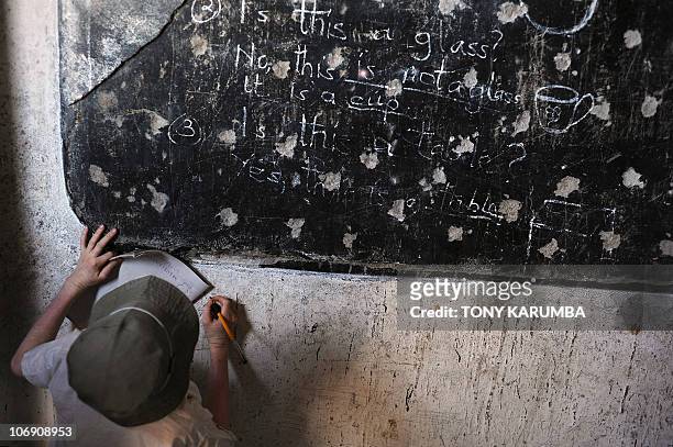 An albino child copies from the blackboard on January 28, 2009 at the Mitindo Primary School for the blind, which has become a rare sanctuary for...