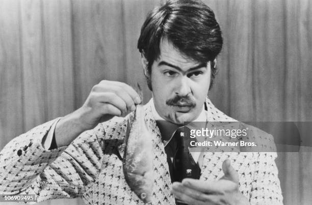 Canadian-American comedian Dan Aykroyd prepares to demonstrate the 'Super Bass-O-Matic' on a sketch from the TV comedy show 'Saturday Night Live',...