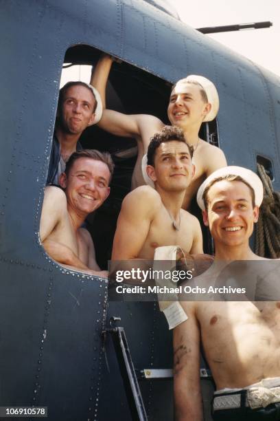 Sailors pose outside a gun turret on the deck of the US Naval Battleship USS Iowa known as 'The Big Stick' in 1943 somewhere in the Atlantic Ocean.