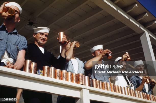 Sailors enjoy large quantities of Ballantine's beer and planters peanuts on the deck of the US Naval Battleship USS Iowa known as 'The Big Stick' in...