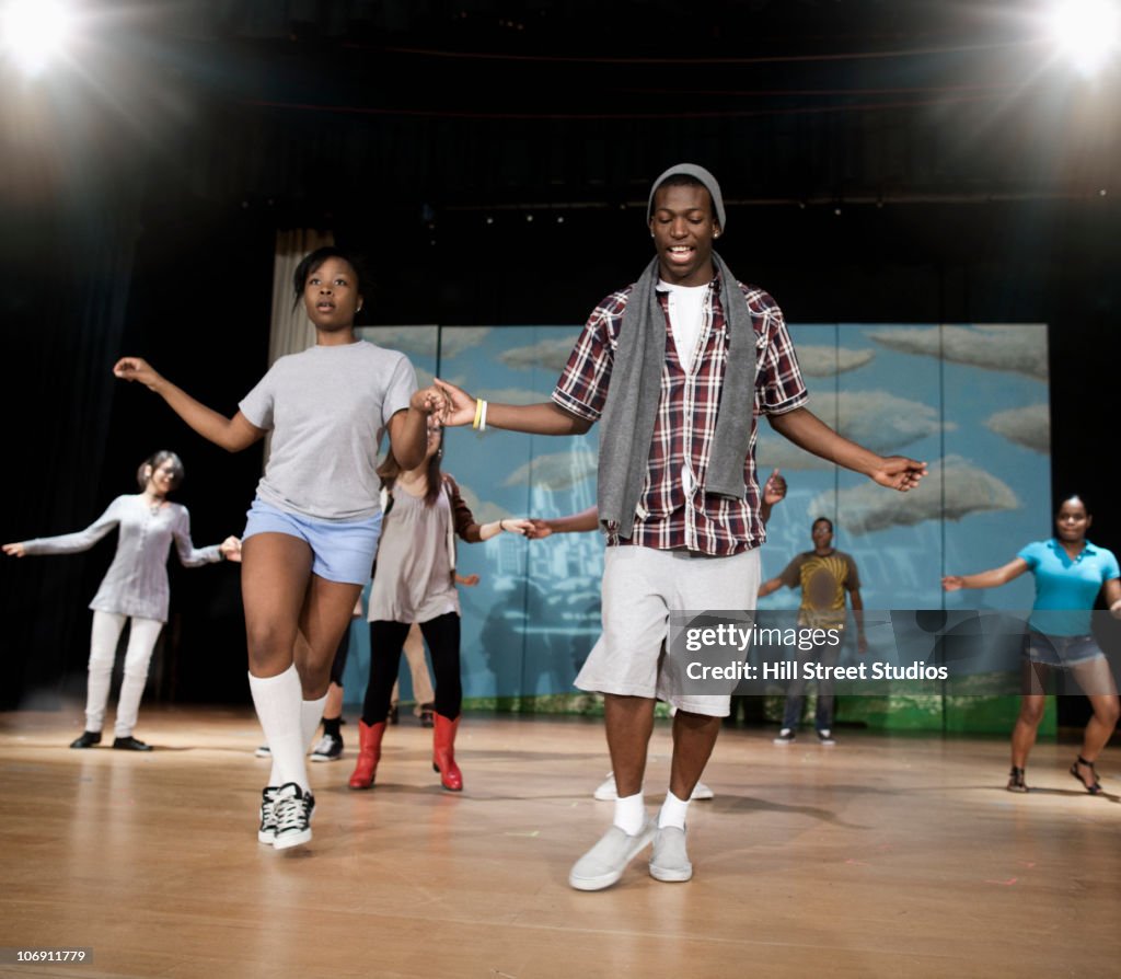 Teenagers rehearsing on stage