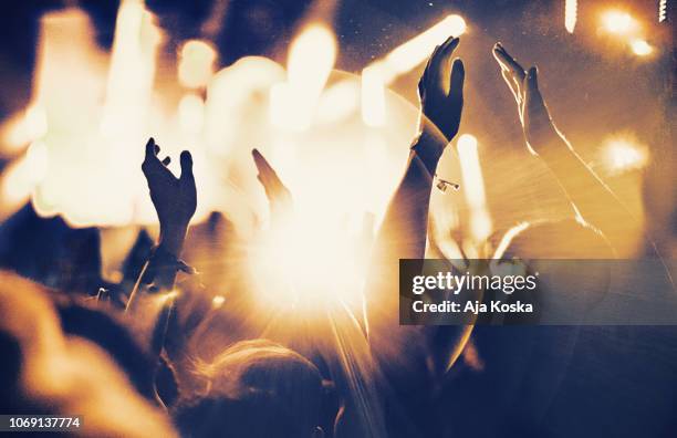 cheering fans at concert. - night out stock pictures, royalty-free photos & images