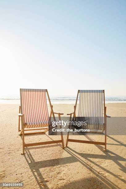 two deck chairs on beach - beach deck chairs stock pictures, royalty-free photos & images