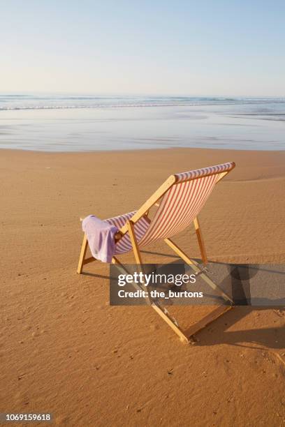 deck chair with towel on beach - striped towel stock pictures, royalty-free photos & images