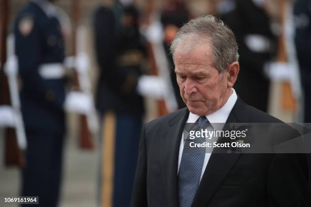 Former President George W. Bush watches as the casket of his father, President George H.W. Bush, is carried from St. Martin's Episcopal Church...