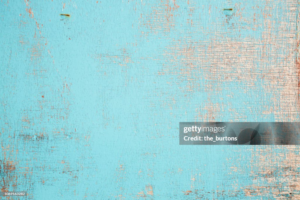 Full frame shot of wooden wall with flaked paint, shabby chic style