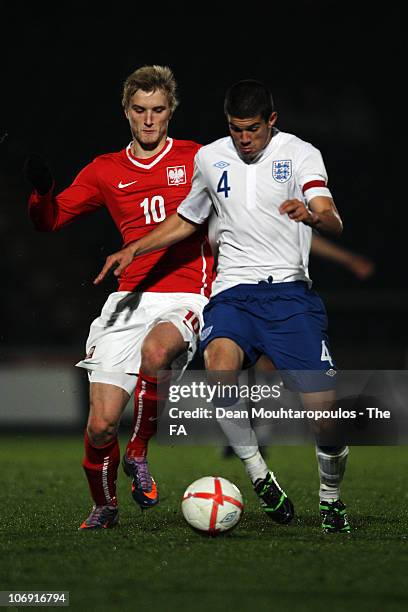 Conor Coady of England and Kacper Przybylko of Poland battle for the ball during the International friendly match between England U18 and Poland U18...