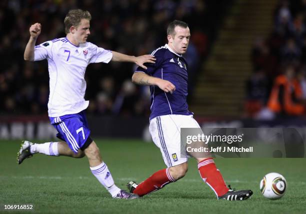 Charlie Adam of Scotland tackles Daniel Udsen of the Faroe Islands during the international friendly match between Scotland and the Faroe Islands at...