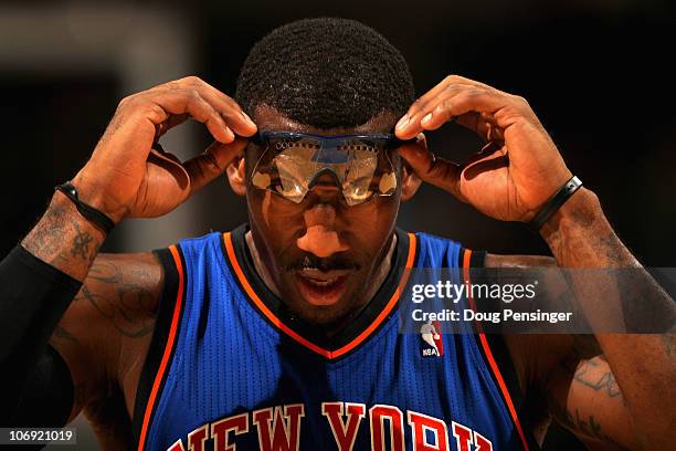 Amar'e Stoudemire of the New York Knicks adjusts his glasses as he faces the Denver Nuggets at the Pepsi Center on November 16, 2010 in Denver,...