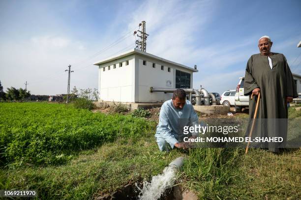Farmers observe water pumping in Kafr al-Dawar village in northern Egypt's Nile Delta, on November 26, 2018. - The country's agricultural heartland...