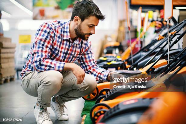 man shopping at a hardware store. - tools stock pictures, royalty-free photos & images