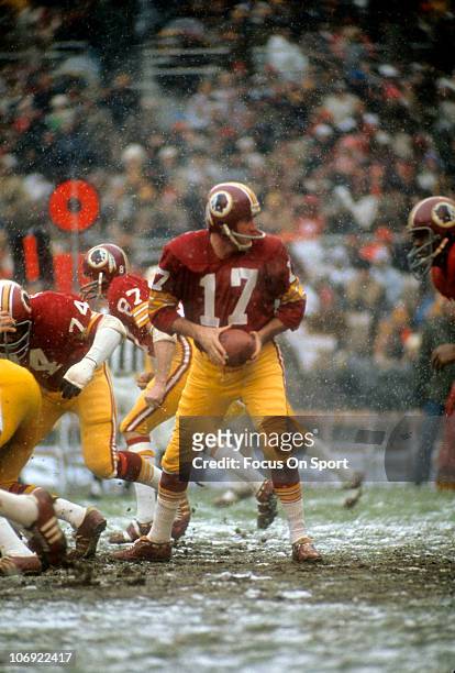 Quarterback Billy Kilmer of the Washington Redskins hands the ball off against the Philadelphia Eagles during an NFL football game at RFK Stadium...