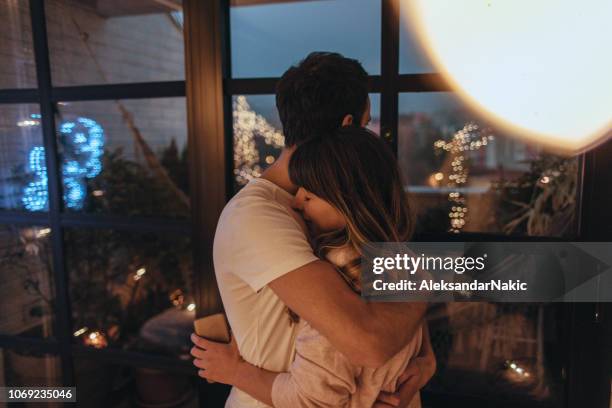 tight hug in christmas night - hug christmas stock pictures, royalty-free photos & images