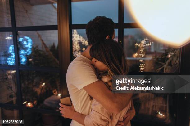 tight hug in christmas night - christmas window stock pictures, royalty-free photos & images