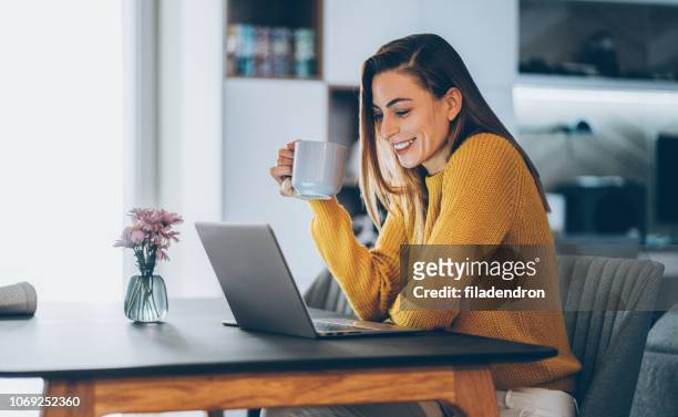 young woman home office - using laptop stock pictures, royalty-free photos & images