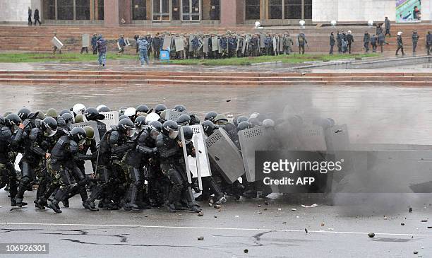 Kyrgyz riot policemen try to stop opposition supporters during an anti-government protest in Bishkek on April 7, 2010. Opposition followers killed...